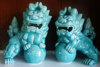  pair of large glazed ceramic foo dogs in a lovely crackled teal