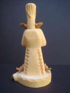 This is a wooden saint sculpture by Gloria Lopez Cordova. The 