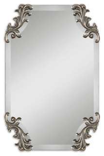 Frameless, shaped beveled mirror accented by decorative corner 