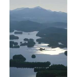 A Floatplane Flies over Long Lake with Mount Marcy in the 